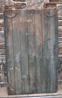Vintage barn door with old rolling hardware and blue paint   Philly 