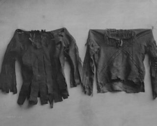 1908 photo Scalp Shirts. Two long sleeved buckskin shirts attached to 