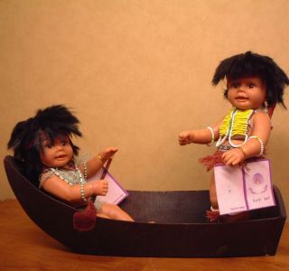 Two Indian Vinyl Poseable Dolls with Wooden Boat