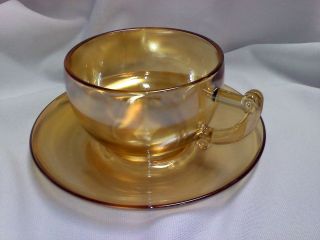 Carnival glass cup and saucers
