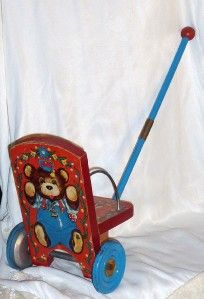 vintage push toy with teddy bear ringing bell