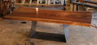 Huge walnut slab and bent steel base dining table