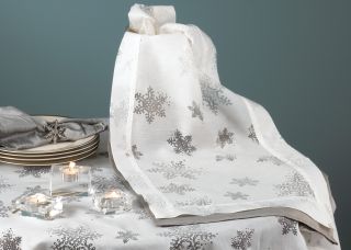 This beautiful table runner features a burnout voile snowflake design