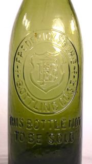 fredericksburg emblem with f b co inside of a shield bottling co s f