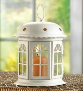 Gracious miniature gazebo lantern shines with golden light through