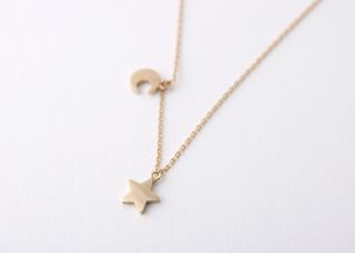 charmed by the out of this world gold crescent moon and star necklace
