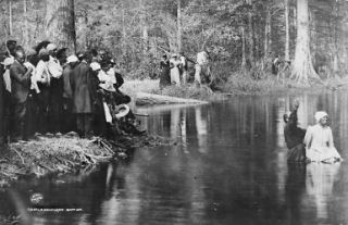 1906 photo Afro American woman being baptized in a stream with others