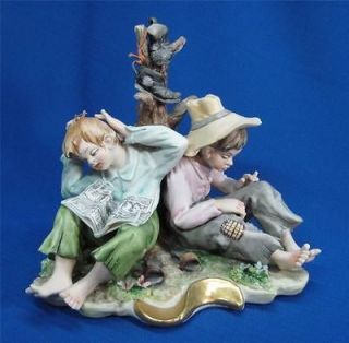 CAPODIMONTE SCULPTURE MODELED BY CORTESE TWO RELAXING BOYS FIGURINE